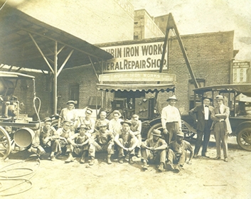 Employees standing in front of the original Rubin Iron Works building over 100 years ago.